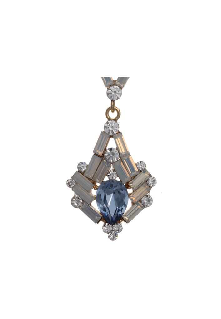 Close-up of a unique jewelry piece featuring a central blue teardrop gem surrounded by various crystal shapes, all set in a gold-tone base.